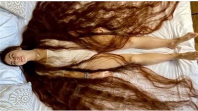 Real life Rapunzel has hair brushing the ground behind her with 90-inches of flowing brown locks.