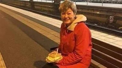 A woman is waiting for a train to return home