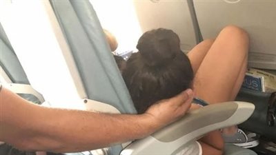 Dad sparks online debate after cradling daughter’s head for 45 minutes so she could sleep during a flight